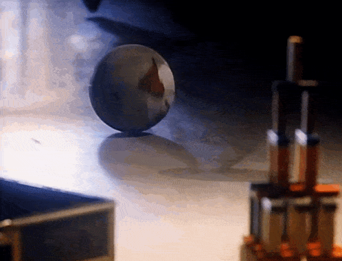 a blurred image of a ball on a table with a few objects in the background
