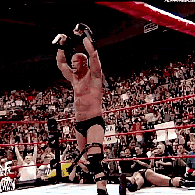 a man in a wrestling ring with a sign that says ga on it