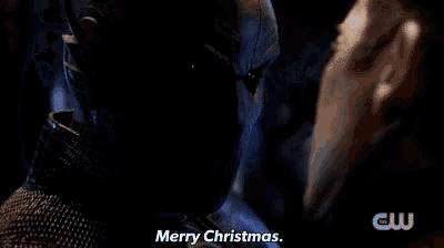a close up of a person 's face with a blue light coming out of it and the words `` merry christmas '' .
