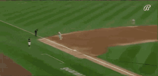 a baseball player with the number 23 on his back is sliding into base