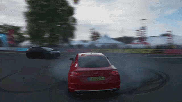 a red car with a license plate that starts with the letter g
