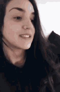 a close up of a woman 's face with long hair .