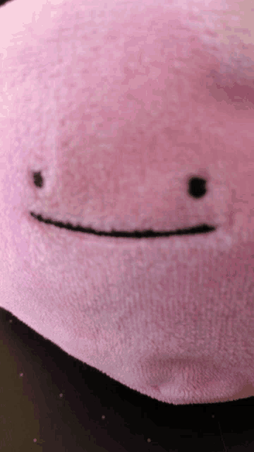 a close up of a stuffed animal with a smile on its face