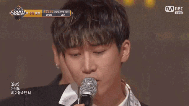 a man singing into a microphone with the number 2236 on the bottom