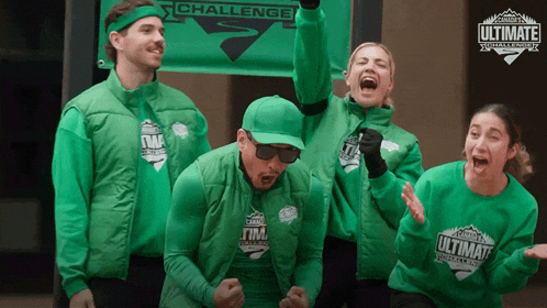 a group of people in green ultimate challenge shirts