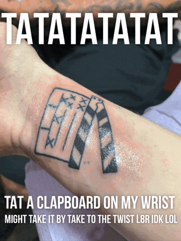 a tattoo of a clapper board on a wrist