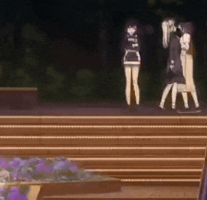 a group of people standing on a set of stairs .