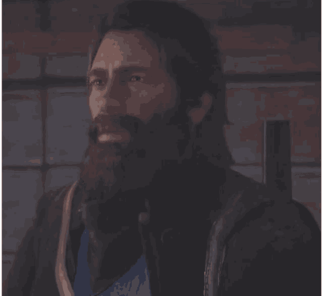 a man with long hair and a beard wearing a leather jacket