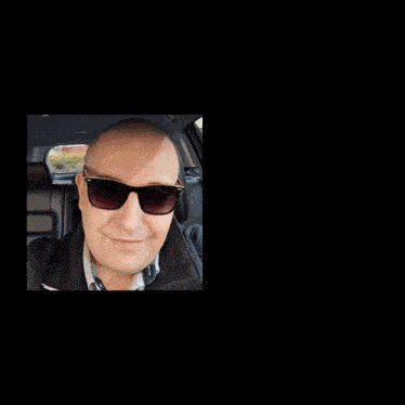 a man wearing sunglasses is reflected in the mirror