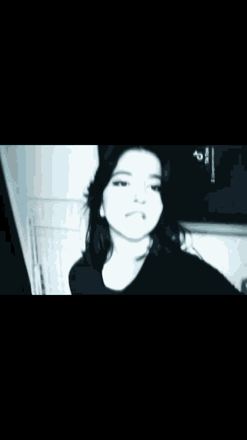 a black and white photo of a woman with tiktok written in the corner