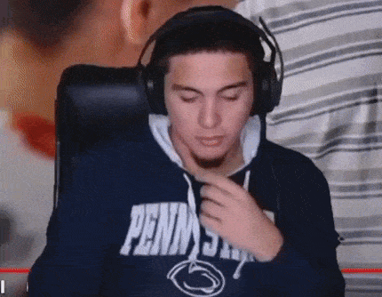 a man wearing headphones and a penn state shirt