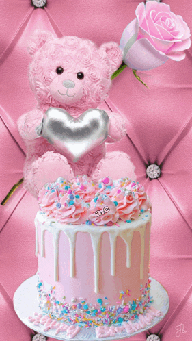 a pink teddy bear holds a heart on top of a cake