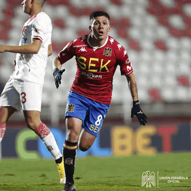 a soccer player wearing a red shirt that says sek on it