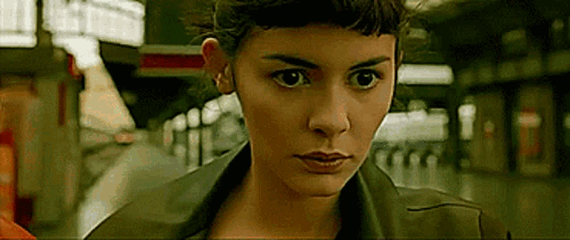 a close up of a woman 's face with a serious look on her face