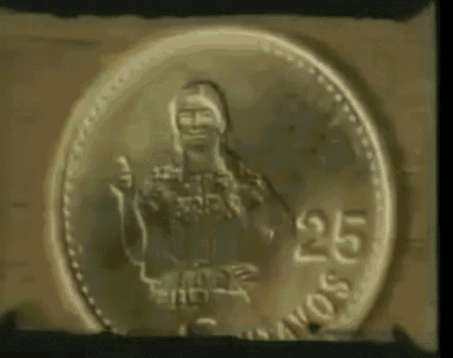 a woman is standing in front of a coin that has the number 25 on it