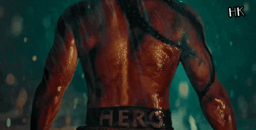 a man 's back is shown in the rain with xhk written on the bottom right