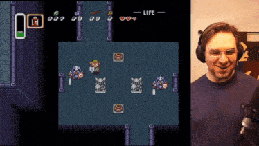 a man wearing headphones is playing a video game and the screen says " life "