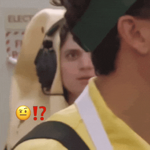 a man in a yellow shirt with a smiley face and a red question mark