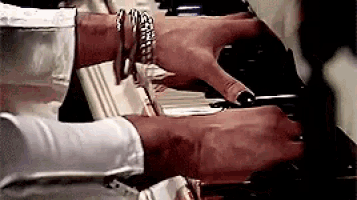 a close up of a person 's hands on a piano keyboard