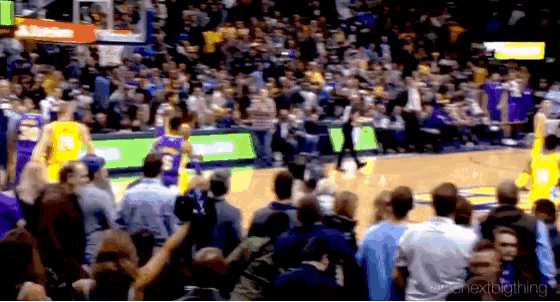 a basketball game is being played in a stadium with a sign that says altitude on it
