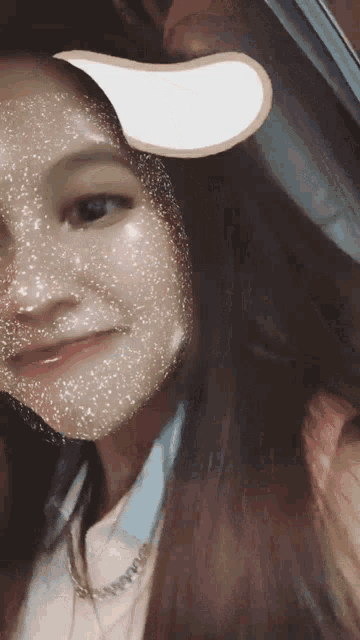 a close up of a woman 's face with a white sticker on it