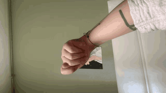 a person with a tattoo on their wrist that says ' a '