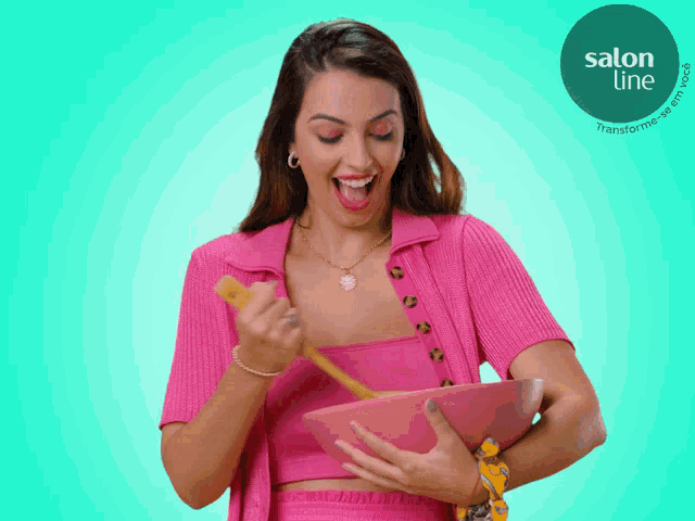 a woman in a pink top is holding a bowl with a spoon in it and a salon line logo in the corner
