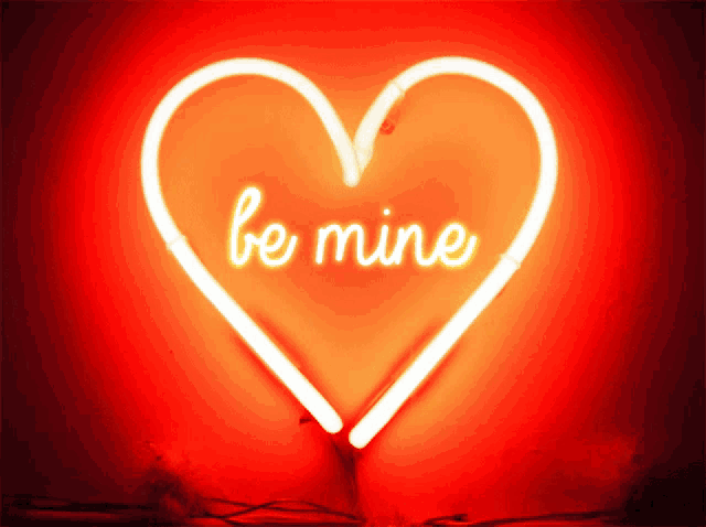 a neon heart that says be mine on it