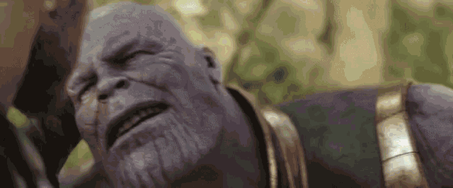 a close up of thanos from avengers infinity war making a funny face