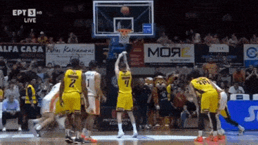a basketball game is being played in front of a crowd and a sign that says alfa casa