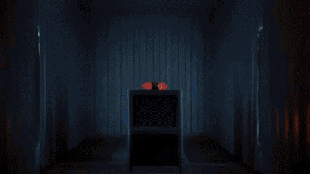 a dark room with a glowing object in the middle