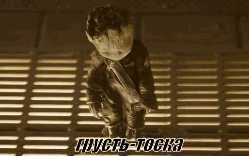 a statue of groot from the movie guardians of the galaxy is sitting on a metal floor .
