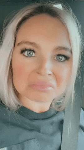 a close up of a woman making a face