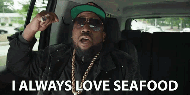 a man in a car with the words i always love seafood