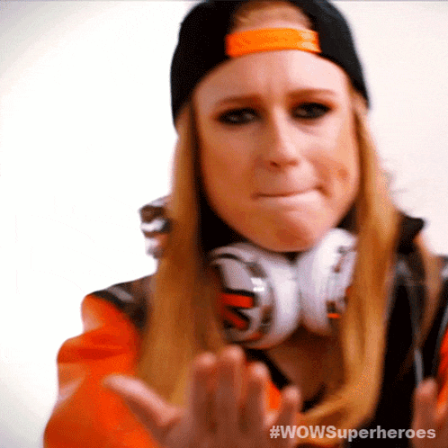 a woman wearing headphones and a hat with #wowsuperheroes written on it