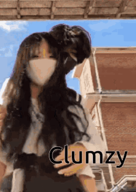 a girl wearing a mask is hugging a boy .