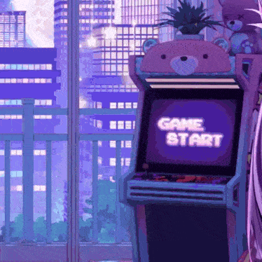 a purple arcade machine with a teddy bear on top says game start