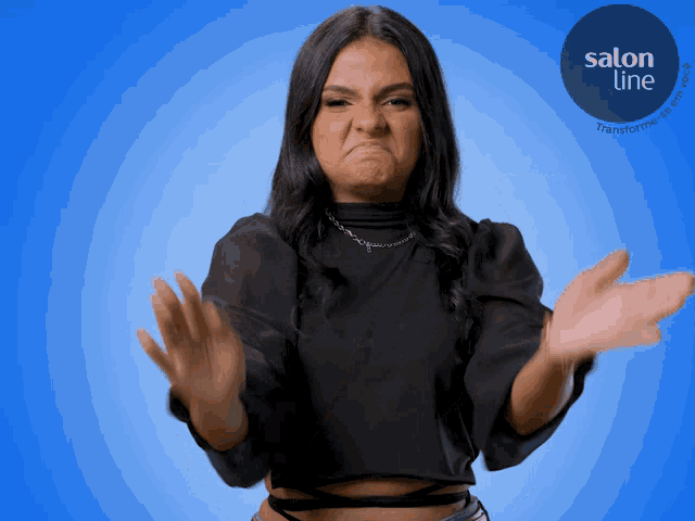 a woman making a face in front of a blue background with salon line written on it