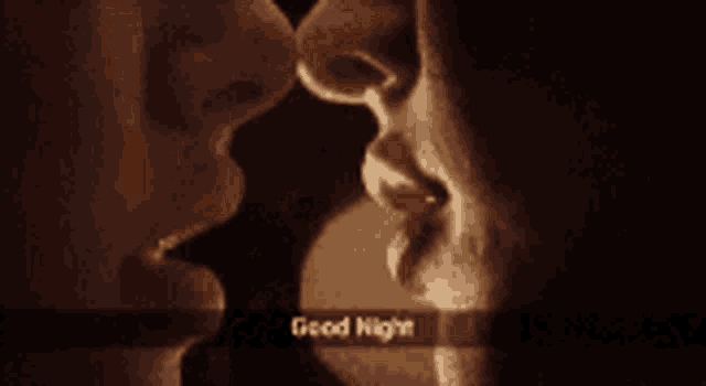 a man and a woman kissing with the words good night written in the corner