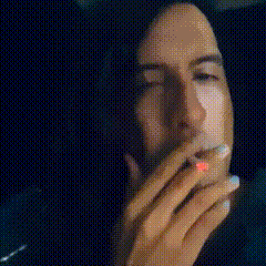 a close up of a woman 's face with a hand on her mouth .