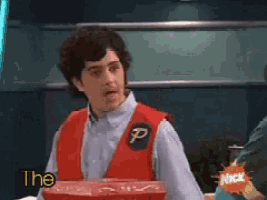 a man in a red vest with a p on it