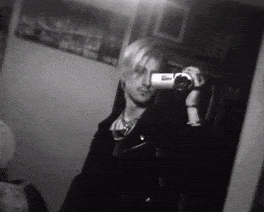 a man is taking a picture of himself in the mirror .