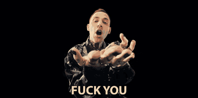 a man with red hair and a black jacket says " fuck you "