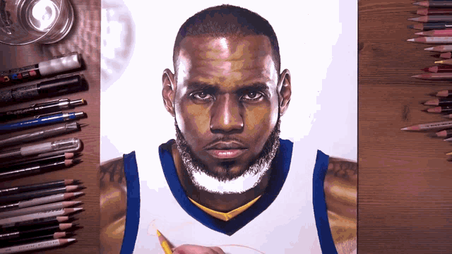 a drawing of lebron james is on a table with colored pencils