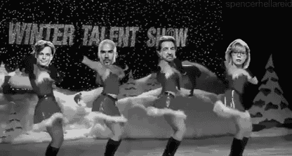a group of people are dancing in front of a winter talent show sign .