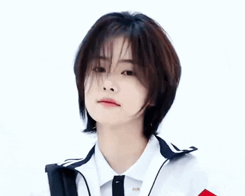 a woman with short hair is wearing a white shirt and a blue jacket