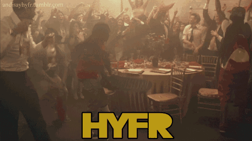 a crowd of people dancing in a room with the word hyfr