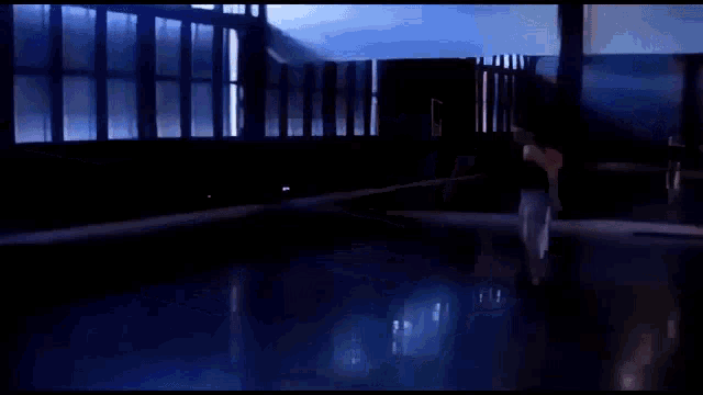 a person is rollerblading on a blue floor