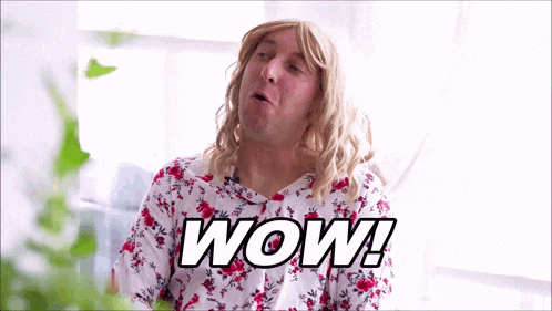 a man wearing a wig and a floral shirt with the word wow written on it