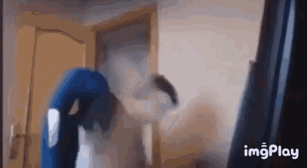 a blurry picture of a person standing in a room with a door .